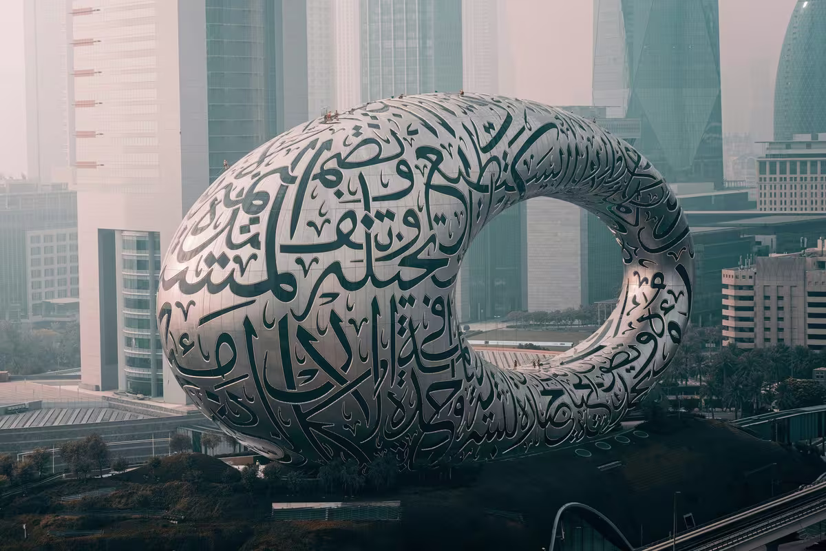 Arabic calligraphy overlaid on a modern digital media production environment representing MENA localization
