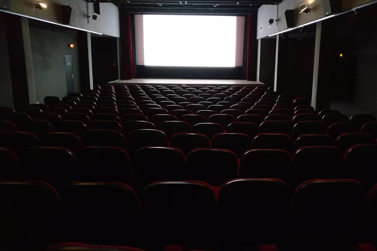 Split-screen comparison of a subtitled film scene and a dubbing studio session representing the localization strategy decision